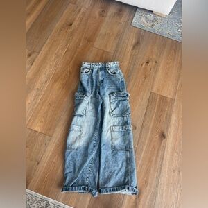 Cute baggy blue/denim jean with cargo pockets to add some detail. Size 2.